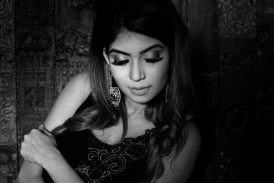 grayscale photo of woman with floral tattoo on her left cheek